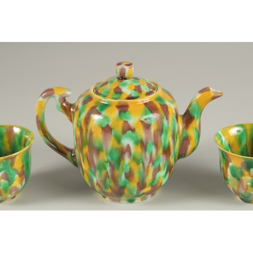 19 - A CHINESE YELLOW GREEN AND BROWN GLAZED PORCELAIN TEAPOT WITH TWO TEACUPS, each with character mark ... 