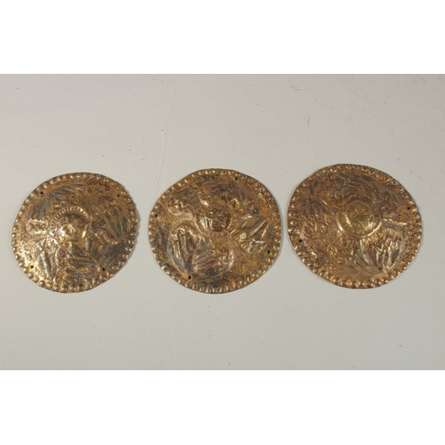 191 - A COLLECTION OF THREE 18TH-19TH CENTURY OTTOMAN ARMENIAN GILT COPPER CIRCULAR PLAQUES, depicting ang... 