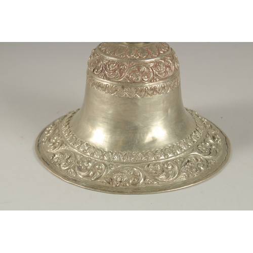 201 - A 19TH CENTURY INDIAN SILVER HUQQA BASE, with bands of embossed and chased foliate decoration, 19cm ... 