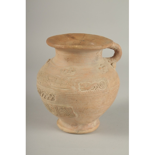 203 - A 10TH CENTURY MIDDLE EASTERN ISLAMIC UNGLAZED POTTERY JUG, with carved calligraphy and animals, 18.... 