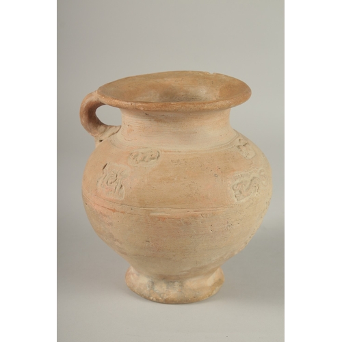 203 - A 10TH CENTURY MIDDLE EASTERN ISLAMIC UNGLAZED POTTERY JUG, with carved calligraphy and animals, 18.... 