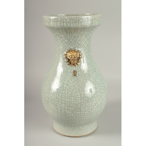 22 - A LARGE CHINESE CELADON CRACKLE GLAZE PORCELAIN VASE, with gilded win handles, 39cm high. Povenance:... 