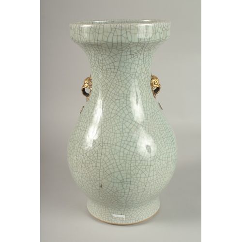 22 - A LARGE CHINESE CELADON CRACKLE GLAZE PORCELAIN VASE, with gilded win handles, 39cm high. Povenance:... 