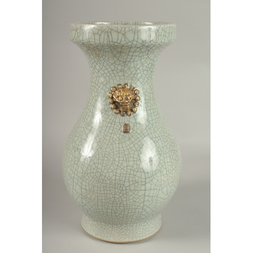 22 - A LARGE CHINESE CELADON CRACKLE GLAZE PORCELAIN VASE, with gilded win handles, 39cm high. Povenance:... 