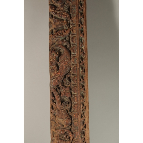 221 - A 16TH-17TH CENTURY INDIAN CARVED WOOD PANEL, with peacock and parrot designs, 136cm long.