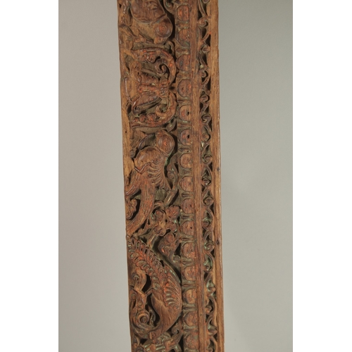 221 - A 16TH-17TH CENTURY INDIAN CARVED WOOD PANEL, with peacock and parrot designs, 136cm long.