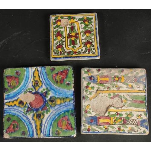 227 - A COLLECTION OF THREE PERSIAN QAJAR TILES, including one with fish designs, largest 13cm square, (3)... 