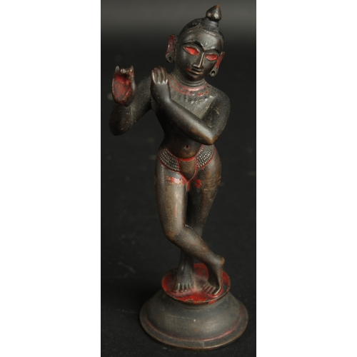 229 - A FINE 18TH CENTURY INDIAN BENGHAL BRONZE FIGURE OF FLUTING KRISHNA, with traces of black and red pi... 