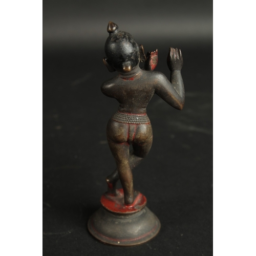 229 - A FINE 18TH CENTURY INDIAN BENGHAL BRONZE FIGURE OF FLUTING KRISHNA, with traces of black and red pi... 