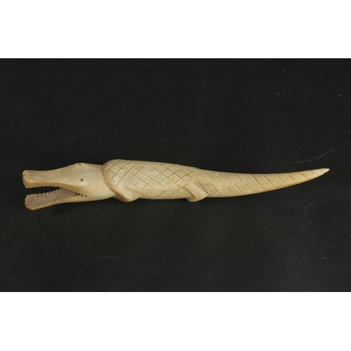 237 - AN EARLY 20TH CENTURY CARVED HORN CROCODILE, 31cm long.