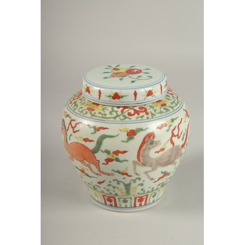 24 - A CHINESE DOUCAI PORCELAIN JAR AND COVER, painted with horses, 16cm high.