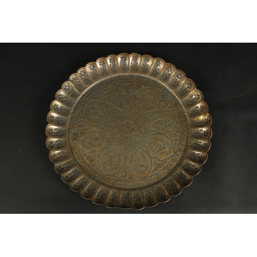 241 - A FINE 18TH CENTURY MUGHAL INDIAN TINNED BRASS CHARGER, signed to the reverse, 34cm wide.