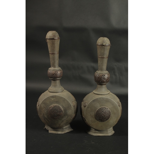 252 - A RARE PAIR OF 18TH CENTURY PERSIAN COPPER MOUNTED LEAD BOTTLES, with openworked panels, 37cm high.