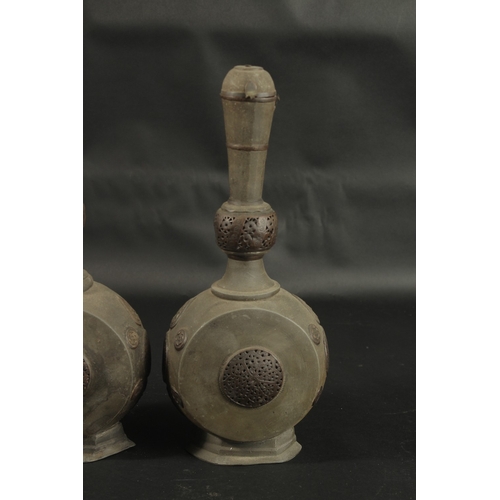 252 - A RARE PAIR OF 18TH CENTURY PERSIAN COPPER MOUNTED LEAD BOTTLES, with openworked panels, 37cm high.