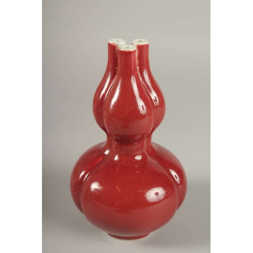 26 - A CHINESE IRON RED GLAZE TULIP VASE, the base with character mark, 20cm high.