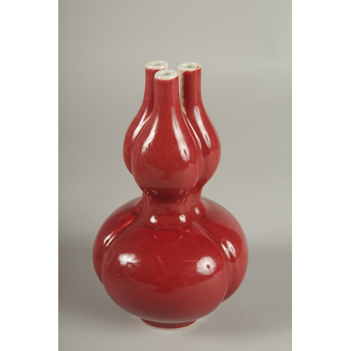 26 - A CHINESE IRON RED GLAZE TULIP VASE, the base with character mark, 20cm high.