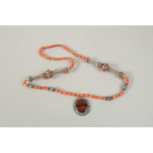 260 - A VERY FINE BUKHARA CORAL BEADED SILVER NECKLACE WITH AGATE PENDANT, adorned with turquoise beads, p... 