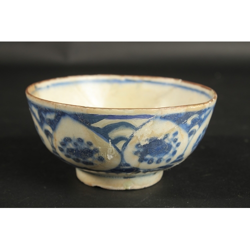 263 - AN EARLY PERSIAN BLUE AND WHITE GLAZED POTTERY BOWL, painted with floral motifs, provenance: formerl... 