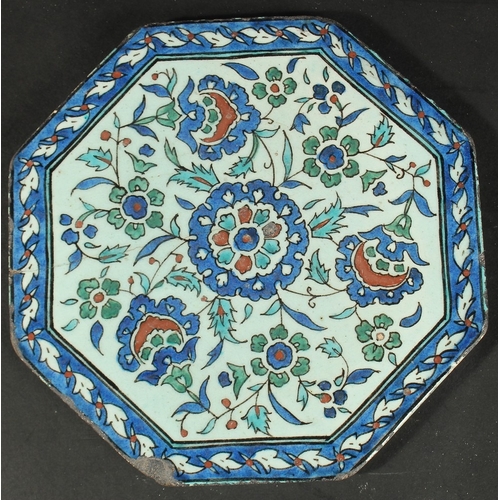 266 - AN ISLAMIC MARKET FRENCH OR ITALIAN GLAZED POTTERY OCTAGONAL TILE, painted with floral motifs, 23cm ... 