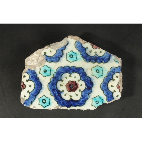 279 - A 16TH CENTURY IZNIK GLAZED POTTERY TILE FRAGMENT, 18.5cm x 14cm.