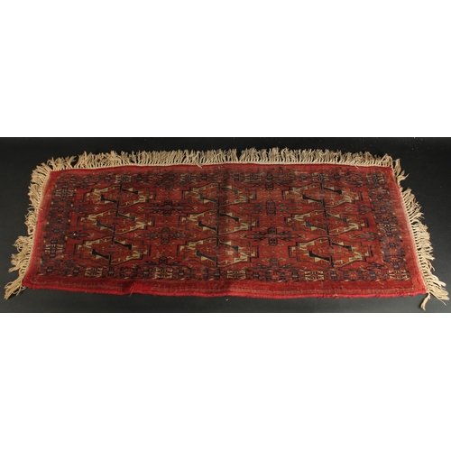 282 - A LATE 19TH CENTURY TEKKE RUG, 120cm x 46cm (excl. tassles).