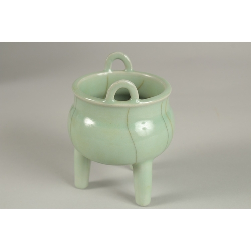 29 - A CHINESE CELADON GLAZE PORCELAIN TRIPOD CENSER, 13cm high.