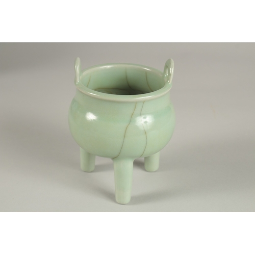 29 - A CHINESE CELADON GLAZE PORCELAIN TRIPOD CENSER, 13cm high.