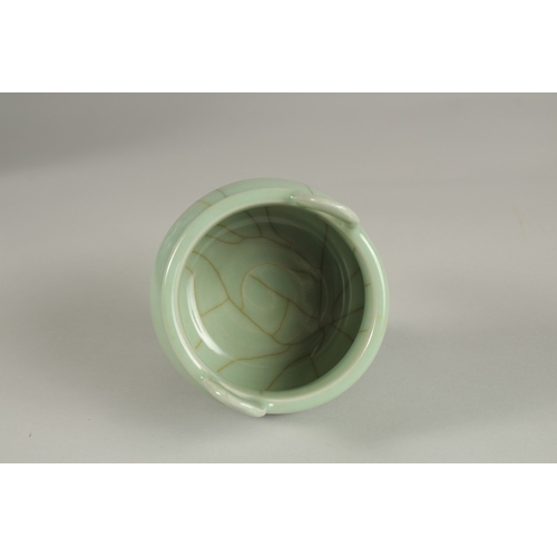 29 - A CHINESE CELADON GLAZE PORCELAIN TRIPOD CENSER, 13cm high.