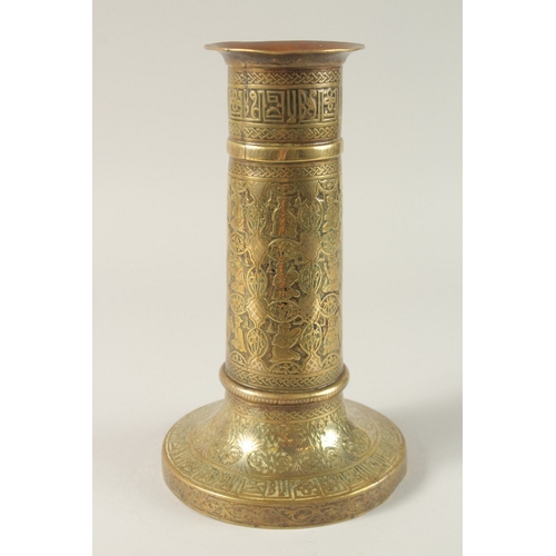 294A - A FINE 19TH CENTURY PERSIAN BRASS CANDLESTICK WITH SILVER INLAYS, the body engraved with seated figu... 