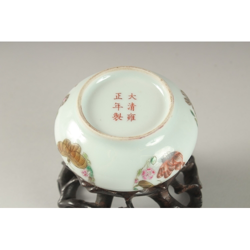 3 - A CHINESE PORCELAIN BOWL ON A CARVED HARDWOOD STAND, the bowl painted with butterflies and bearing s... 