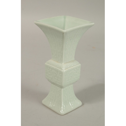 301 - A CHINESE CELADON MINIATURE PORCELAIN GU VASE, with six-character mark, 12.2cm high.