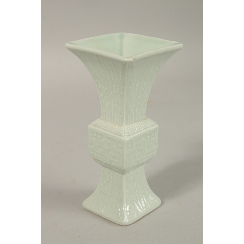 301 - A CHINESE CELADON MINIATURE PORCELAIN GU VASE, with six-character mark, 12.2cm high.