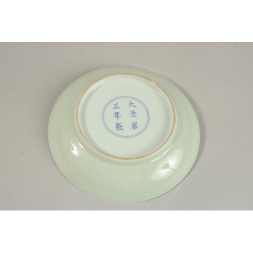 302 - A CHINESE CELADON GLAZE PORCELAIN DISH, with six-character mark, 15cm diameter.