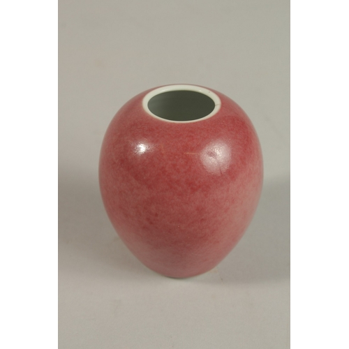 305 - A CHINESE COPPER RED PORCELAIN BRUSH POT, with four-character mark, (af), 8cm.