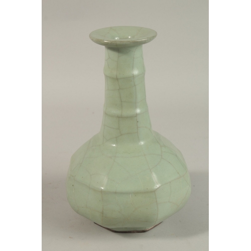 309 - A CHINESE CRACKLE GLAZE CELADON BOTTLE VASE, 23.5cm high.