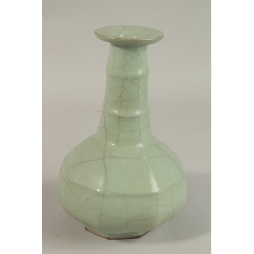 309 - A CHINESE CRACKLE GLAZE CELADON BOTTLE VASE, 23.5cm high.