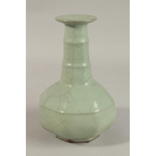 309 - A CHINESE CRACKLE GLAZE CELADON BOTTLE VASE, 23.5cm high.