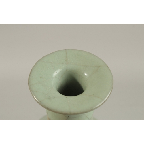 309 - A CHINESE CRACKLE GLAZE CELADON BOTTLE VASE, 23.5cm high.