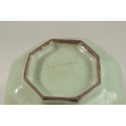 309 - A CHINESE CRACKLE GLAZE CELADON BOTTLE VASE, 23.5cm high.