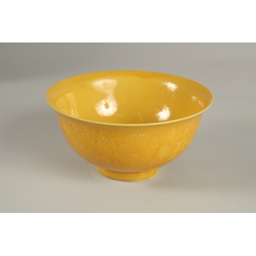 31 - A CHINESE YELLOW GLAZE PORCELAIN BOWL, with incised decoration, base with character mark, 15cm diame... 