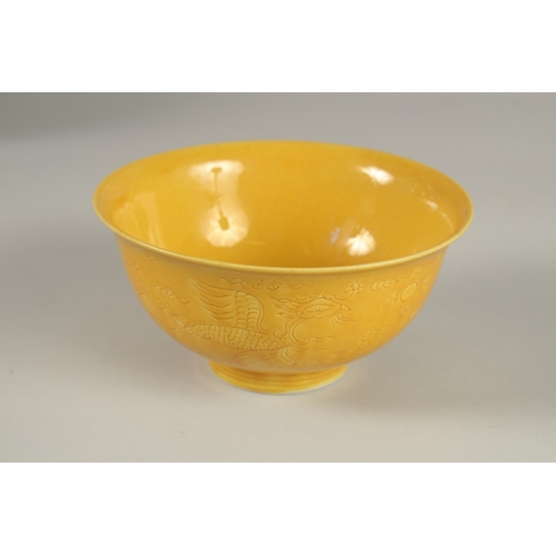 31 - A CHINESE YELLOW GLAZE PORCELAIN BOWL, with incised decoration, base with character mark, 15cm diame... 