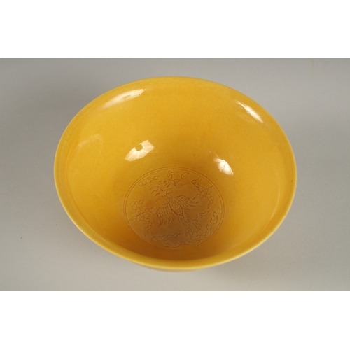 31 - A CHINESE YELLOW GLAZE PORCELAIN BOWL, with incised decoration, base with character mark, 15cm diame... 