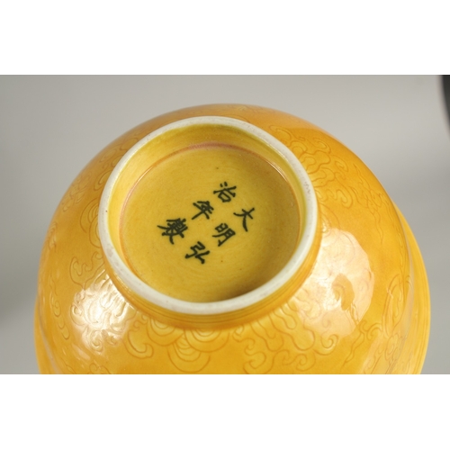 31 - A CHINESE YELLOW GLAZE PORCELAIN BOWL, with incised decoration, base with character mark, 15cm diame... 