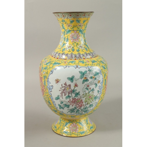 310A - A CHINESE YELLOW GROUND ENAMELLED VASE, painted with a panel depicting an exotic bird and flora, fur... 