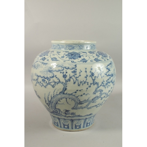 310 - A LARGE CHINESE BLUE AND WHITE PORCELAIN JARDINIERE, painted with trees and clouds, 34cm high.