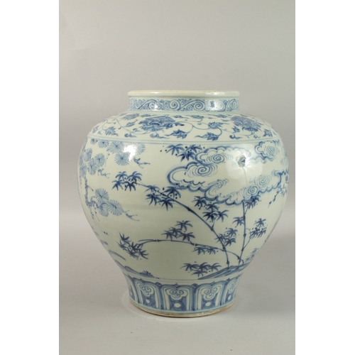 310 - A LARGE CHINESE BLUE AND WHITE PORCELAIN JARDINIERE, painted with trees and clouds, 34cm high.