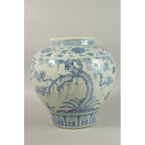 310 - A LARGE CHINESE BLUE AND WHITE PORCELAIN JARDINIERE, painted with trees and clouds, 34cm high.