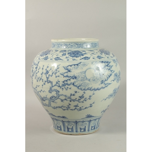 310 - A LARGE CHINESE BLUE AND WHITE PORCELAIN JARDINIERE, painted with trees and clouds, 34cm high.