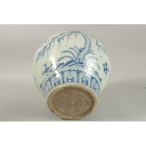 310 - A LARGE CHINESE BLUE AND WHITE PORCELAIN JARDINIERE, painted with trees and clouds, 34cm high.