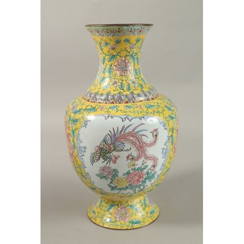 310A - A CHINESE YELLOW GROUND ENAMELLED VASE, painted with a panel depicting an exotic bird and flora, fur... 